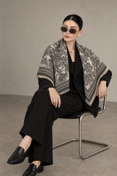 GREY cashmere animal print square shawl folded into a triangle — seated