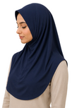 Woman wearing a navy hijab against a beige background